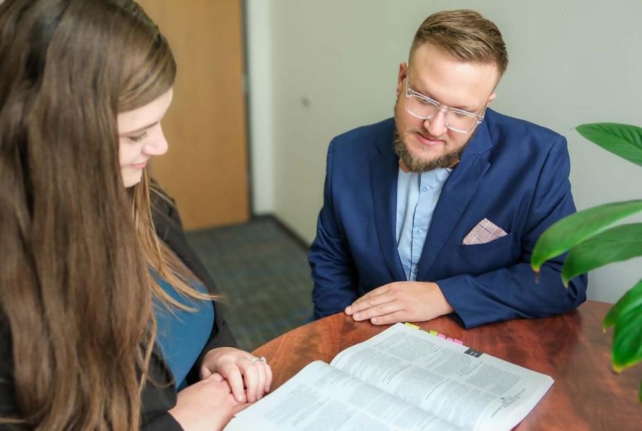 A woman together with her public defender, reviewing paperwork